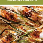 Apricot chicken on a sheet pan with charred scallions.