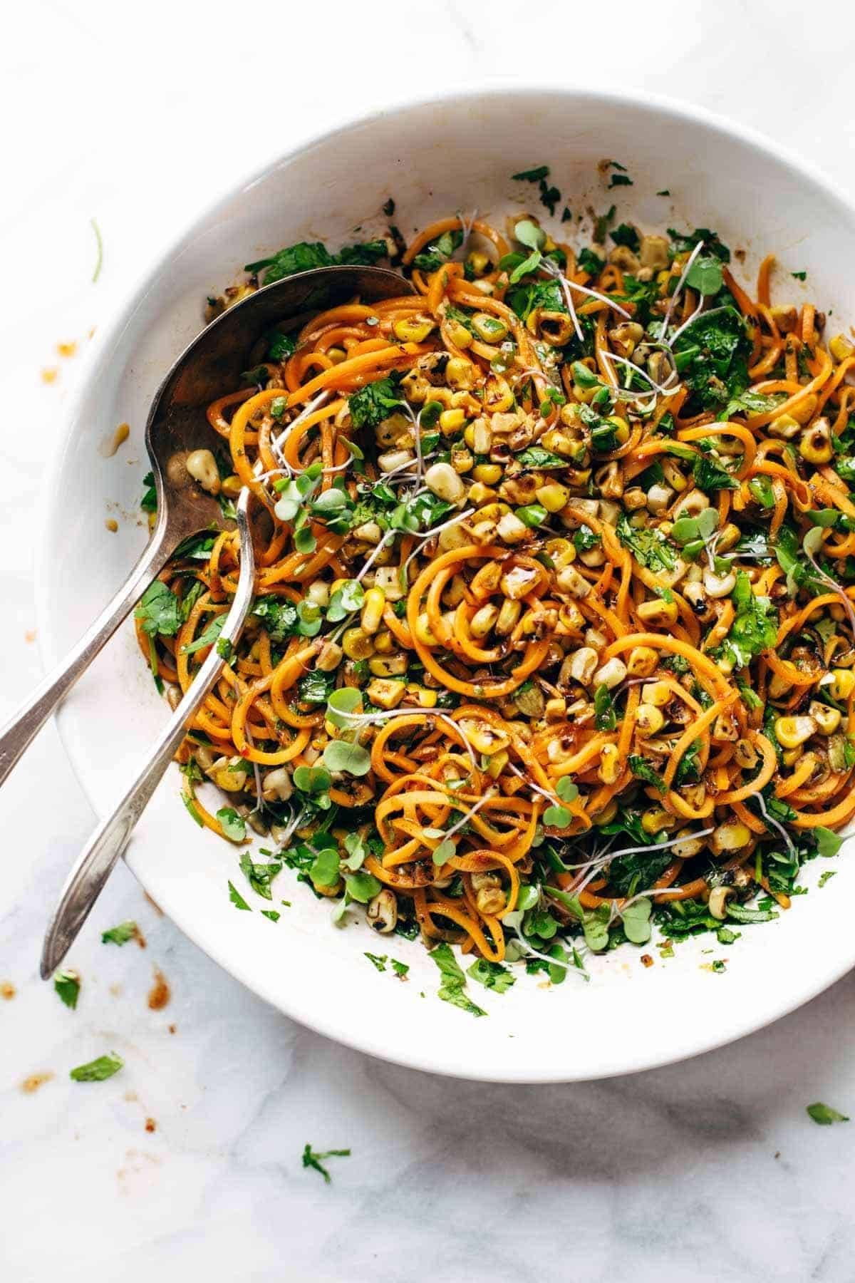 Sweet Potato Noodle Salad in serving bowl with spoons.